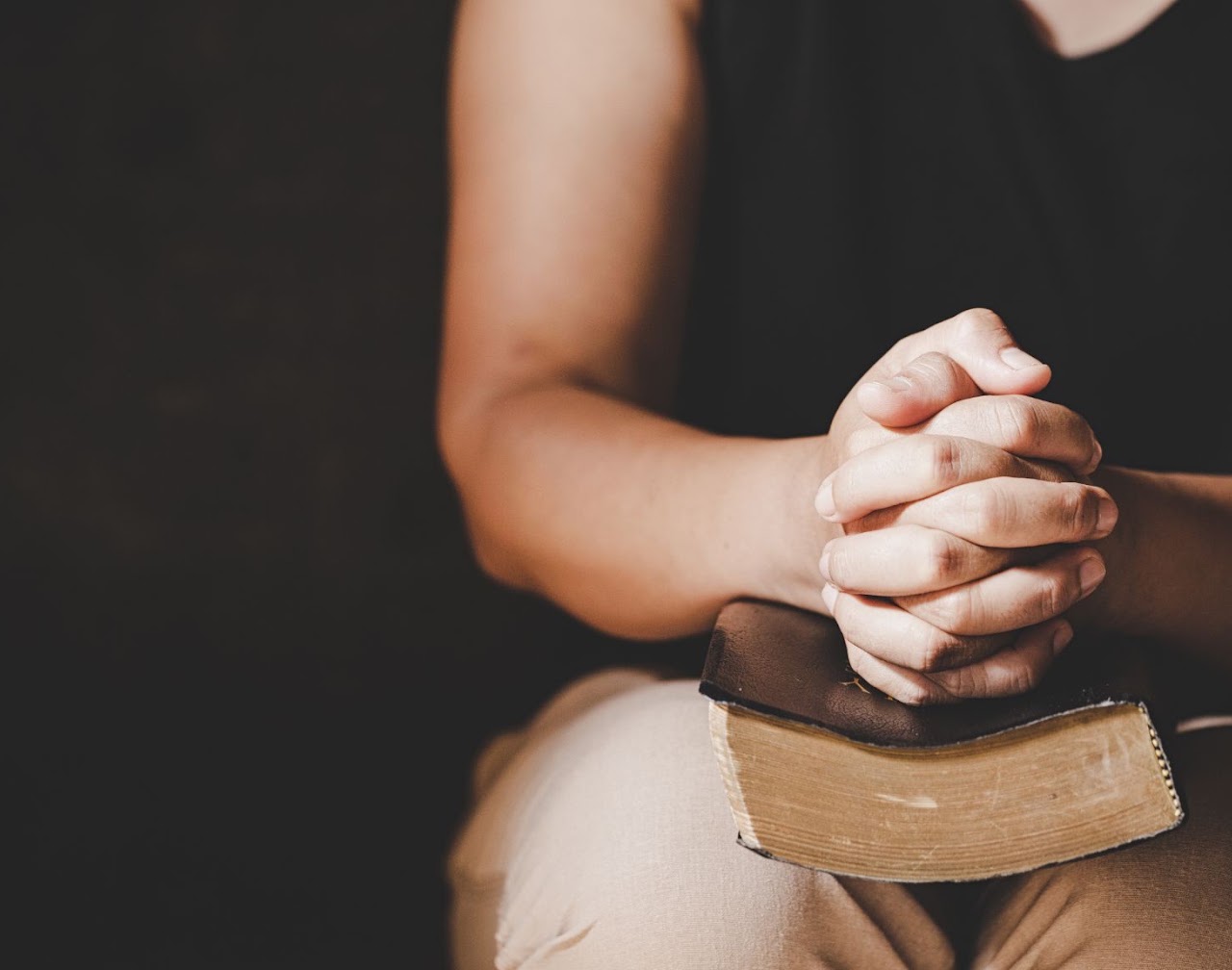 Hands clasped in prayer